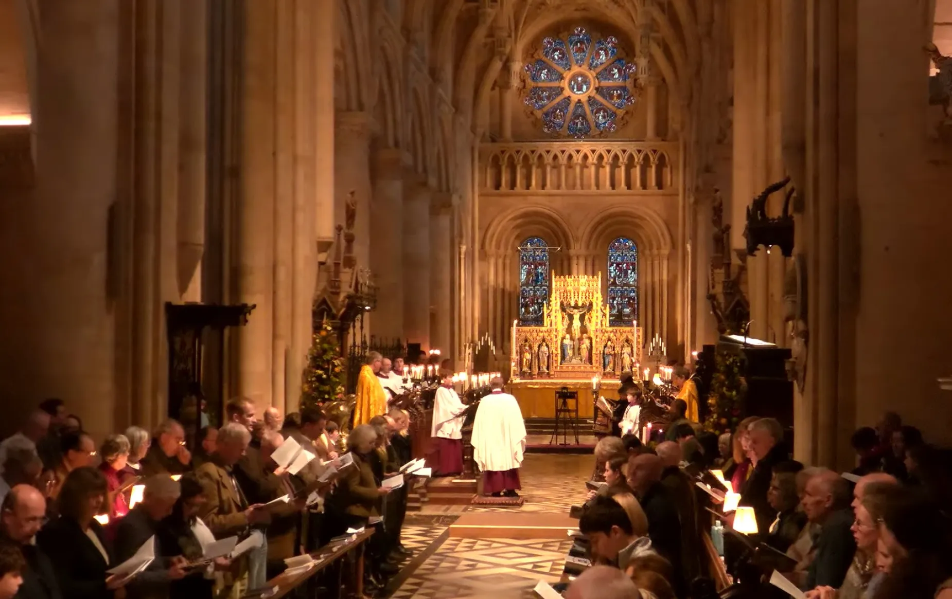 The Cathedral nave is full of worshippers, choir and clergy for a Christmas Eve service of nine lessons and carols. A Christmas tree by the sub dean's stall is adding festive cheer.