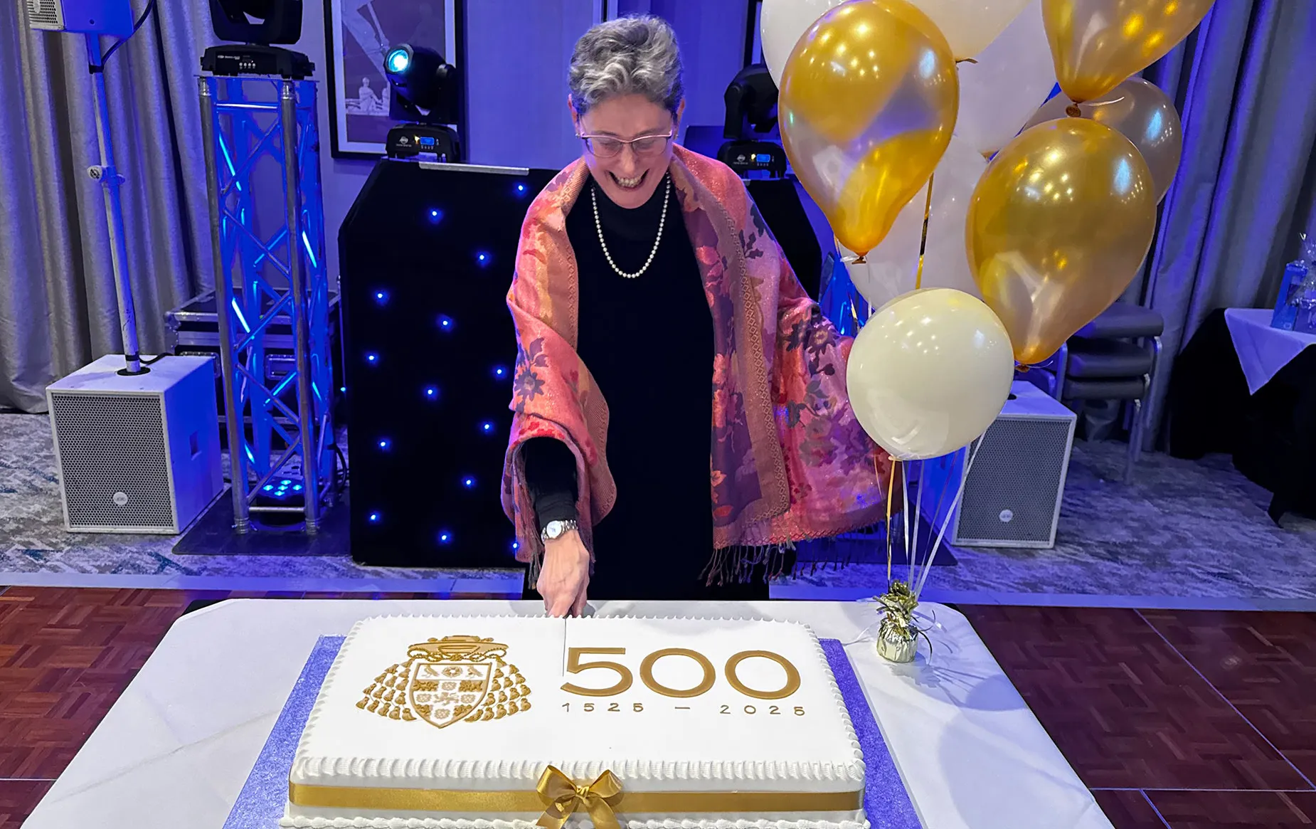 The Dean cutting a celebration cake at the staff party