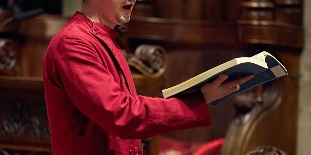 A Lay Clerk singing during a concert