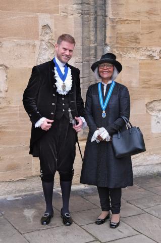 Alexander Barfield, High Sheriff of the Royal County of Berkshire, and Kurshida Mirza, High Sheriff of Buckinghamshire, smile together in Tom Quad