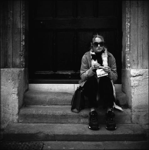 A woman sat on steps in Oxford