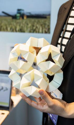 Dr Liu displays an origami model at the Dubai exhibition