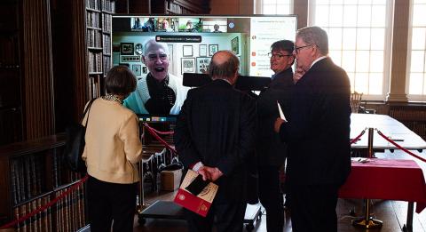 Event attendees listen to Jon A. Lindseth, who spoke to them via video link