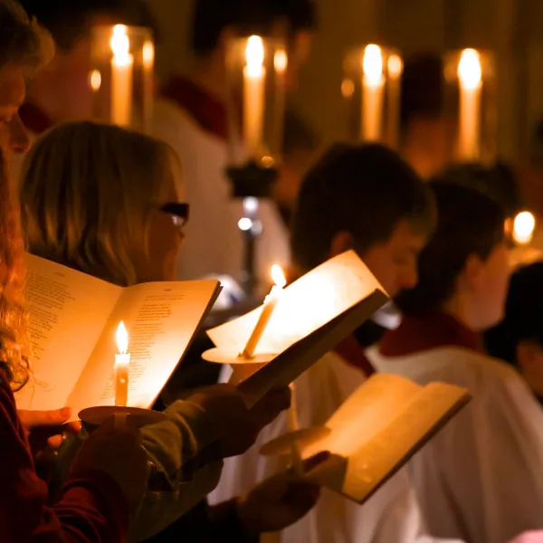 Choir and congregation singing by candlelight