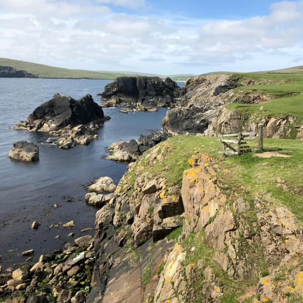Rocky cliffs of Unst, a beautiful island in the north of the Shetlands, with the sea below.