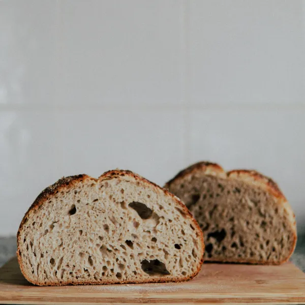 A loaf of bread cut in half on a chopping board