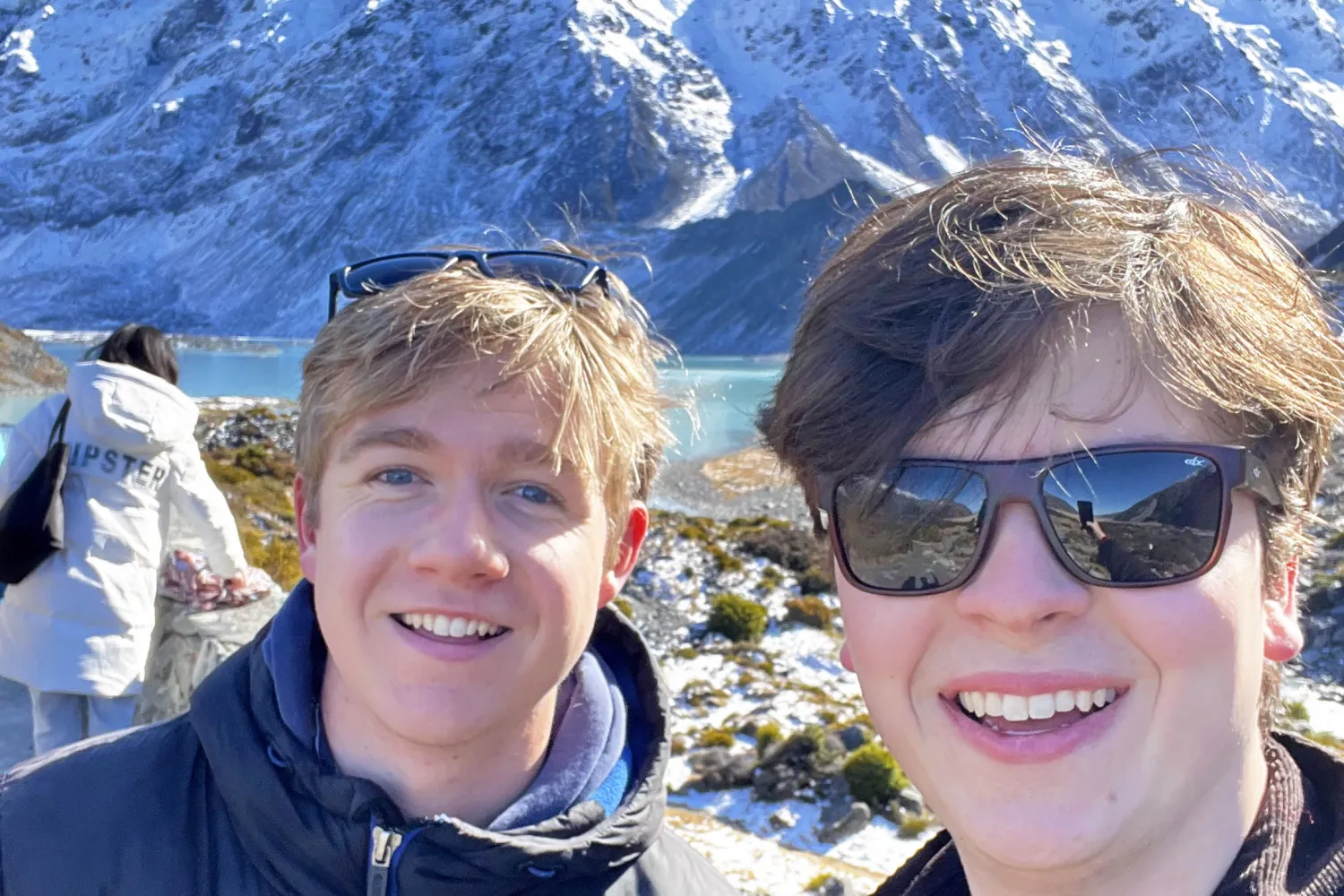 James Parmeter and George Blundell in front of mountains and a lake