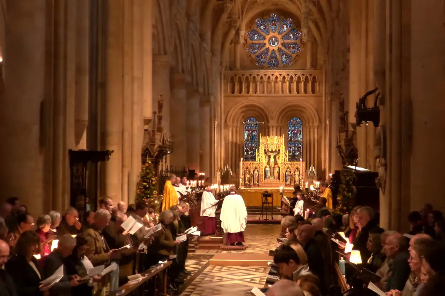 The Cathedral nave is full of worshippers, choir and clergy for a Christmas Eve service of nine lessons and carols. A Christmas tree by the sub dean's stall is adding festive cheer.