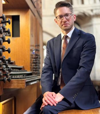 Peter Holder, new organist of Christ Church, sits at the wooden console of the Rieger Organ.