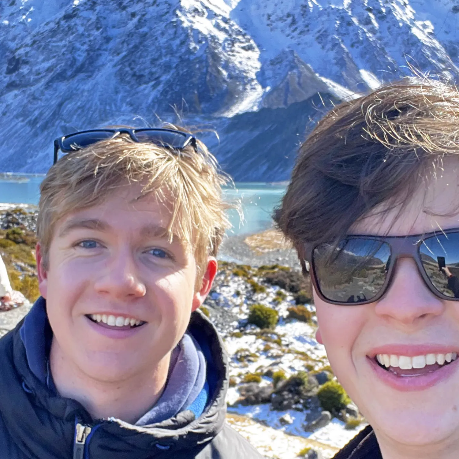 James Parmeter and George Blundell in front of mountains and a lake